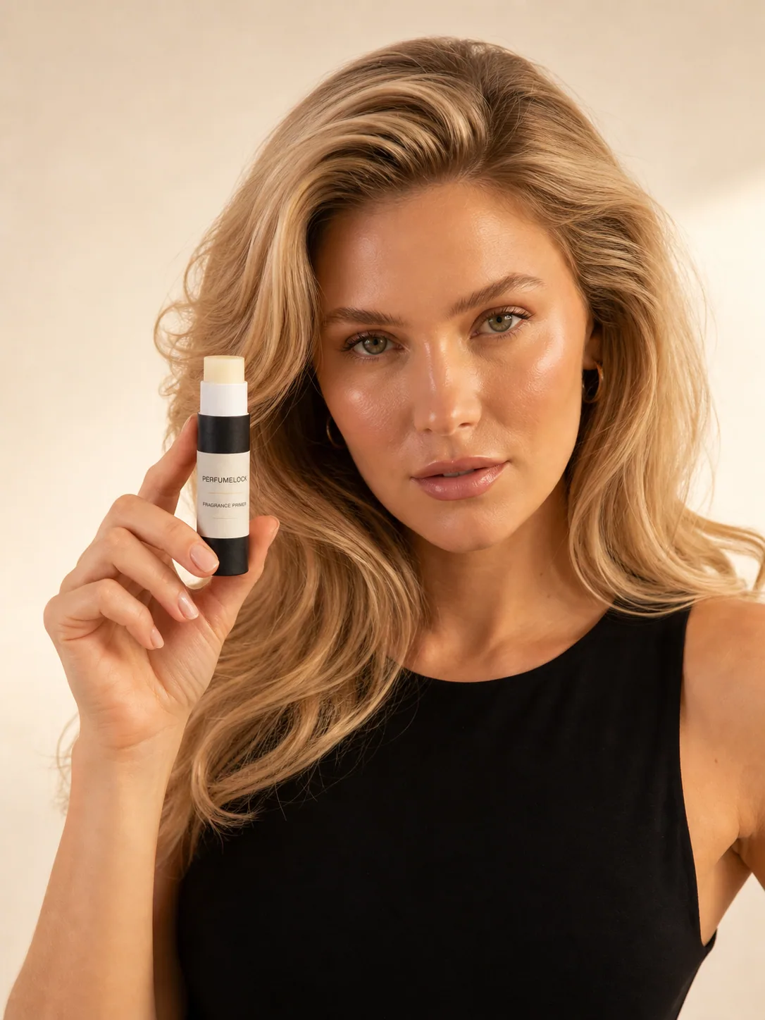 Woman holding the slim PerfumeLock fragrance primer