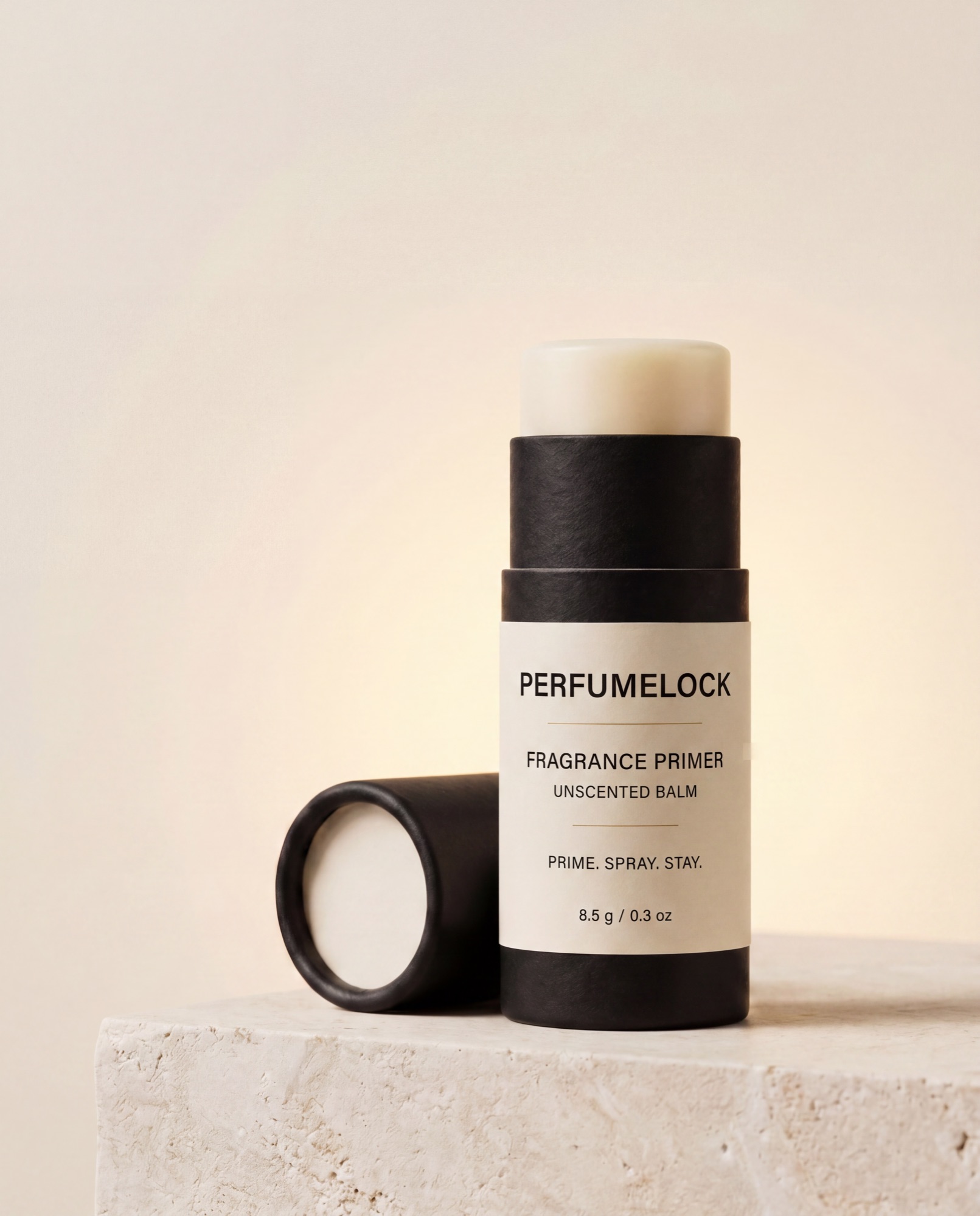 PerfumeLock stick standing on a stone plinth, cap resting beside it